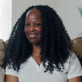 black woman standing beside white man talking